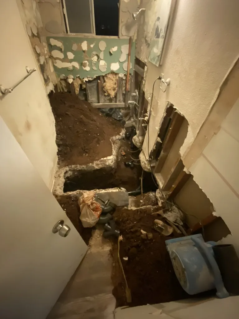 Bathroom floor and walls torn open during the duplex sewer line repair