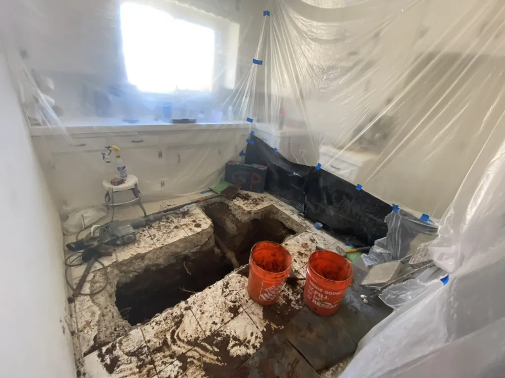 Kitchen floor jackhammered open to replace the duplex sewer line